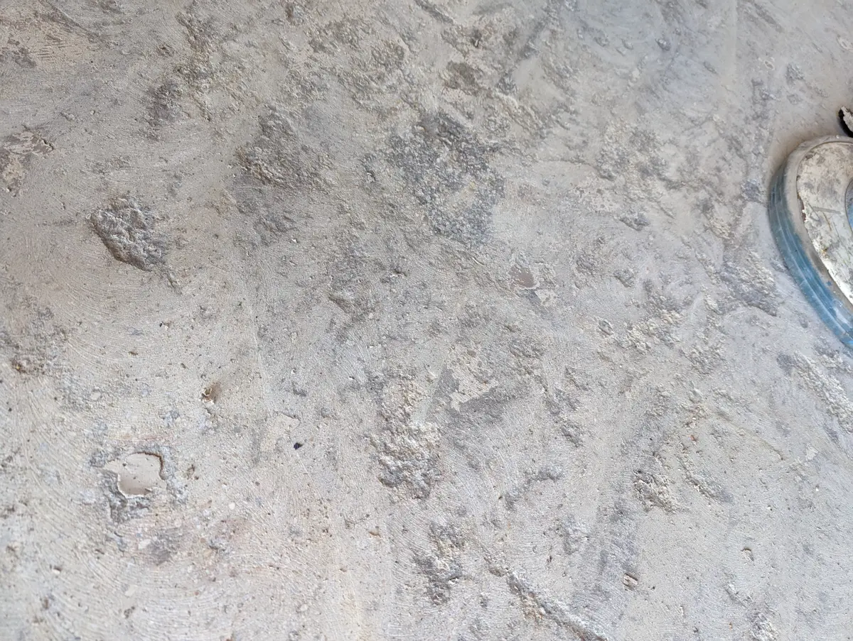 Close-up of damaged concrete surface before floor coating preparation