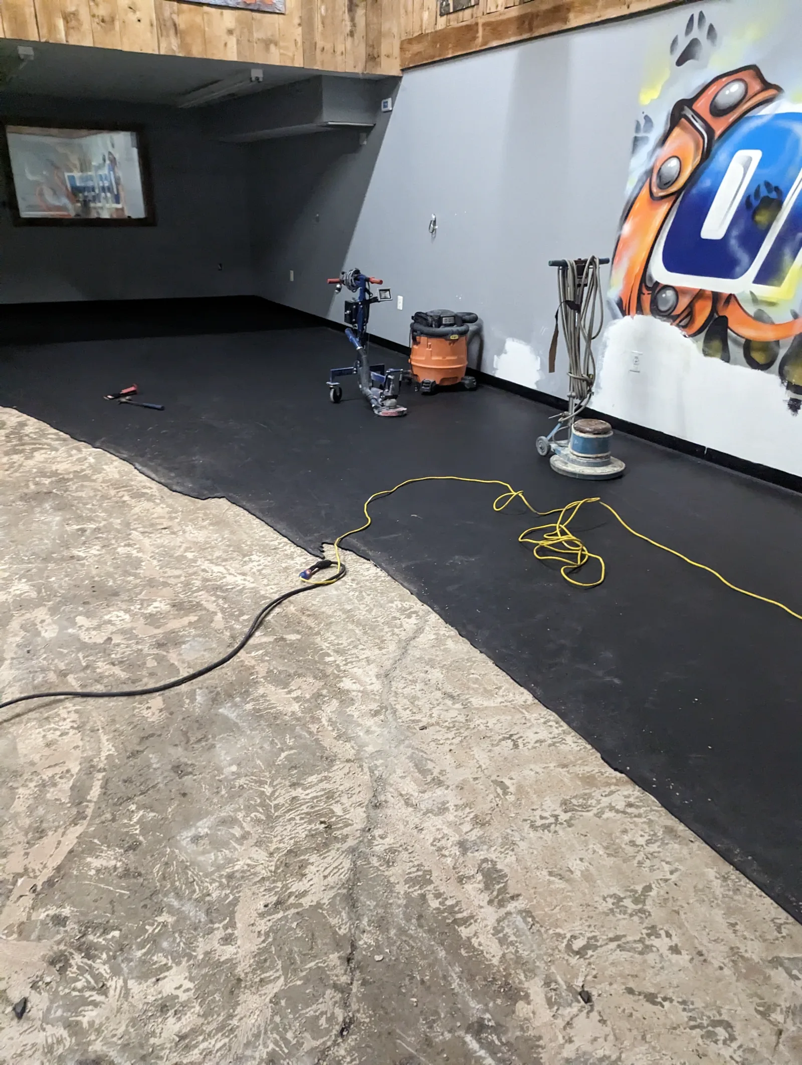 Old floor coating being removed before epoxy floor recoating