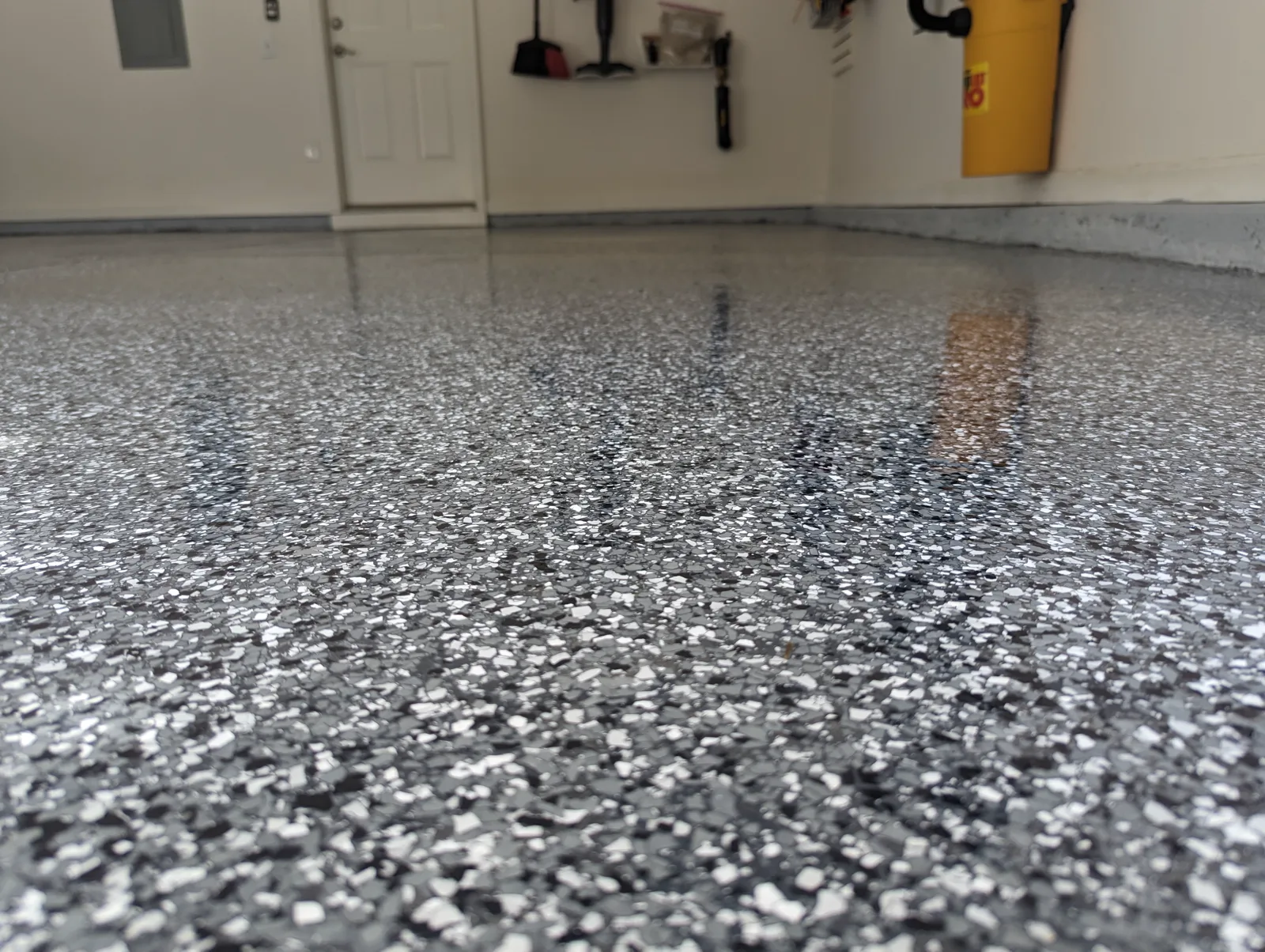 Finished residential garage floor with a gray flake epoxy coating